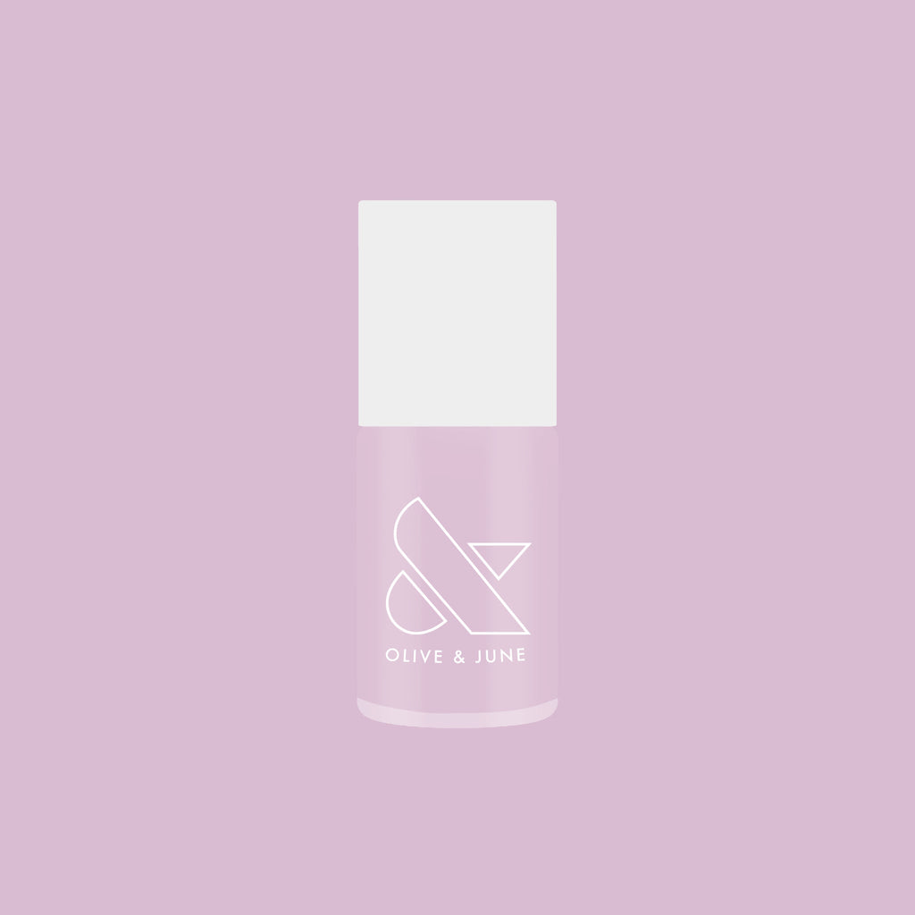 Bottle of Passionfruit Gloss quick dry gel polish in milky lavender shade on soft purple background