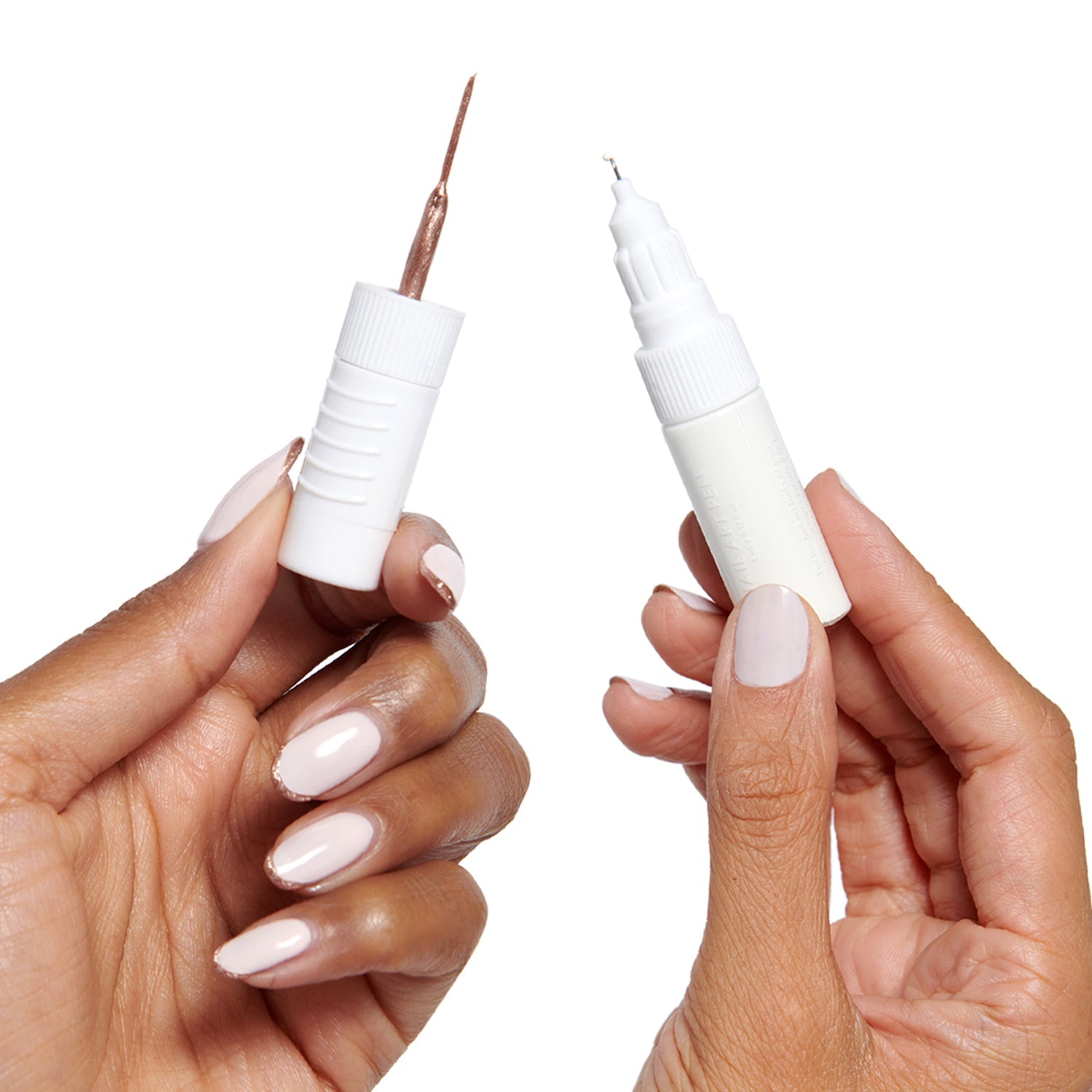 Hands holding a double-sided Nail Art Pens tool with fine tip and brush for detailed at-home manicures